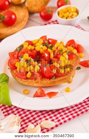 Friselle With Tomatoes And Mais On White Dish.