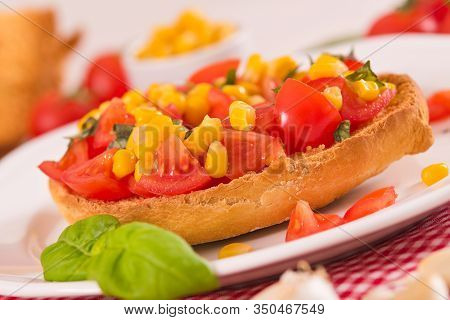 Friselle With Tomatoes And Mais On White Dish.