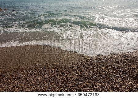 Waves Of The Sea Reaching The Shore Of The Beach