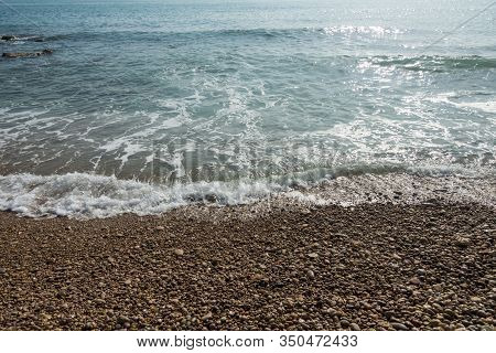 Waves Of The Sea Reaching The Shore Of The Beach