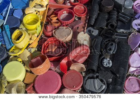 Close-up Of Plastic Trash Spilled On The Beach, Dirty Sea Sandy Shore, Environmental Pollution, Ecol