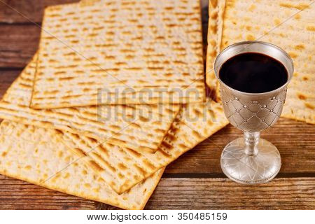 Matzah And A Silver Cup Full Of Wine. Jewish Holidays Passover Concept.