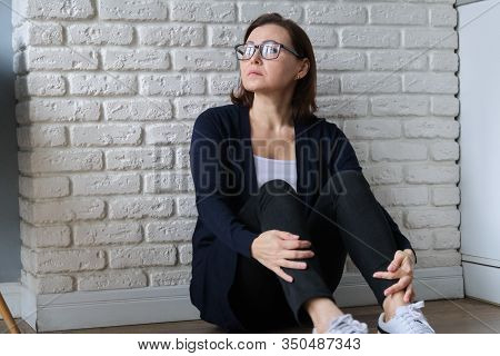 Sad Depressed Age Lonely Woman Sitting On Floor. Depression, Melancholy, Problems With Barometric Pr