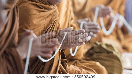 Buddhist Monk Praying Hands In Buddhism Tradition Ceremony.