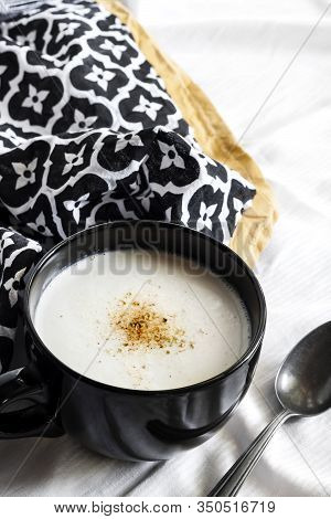 Cauliflower Soup (creme Du Barry) In Black Bowl On White Background With Black And White Cloth. Fren
