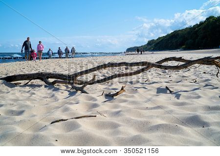 Rewal, Poland - September 05, 2019: Flotsam On A Beach With Holidaymakers On The Polish Baltic Coast