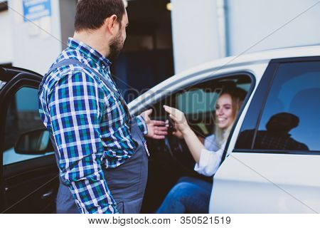 Car Service Worker Taking Car Keys Of Woman For Providing Technical Assistance Of Car