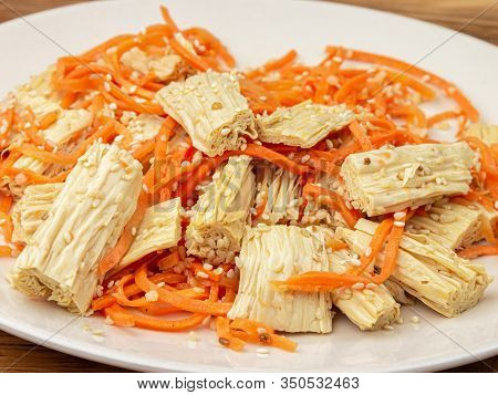 Close-up Spicy Chinese Or Korean Yuba Tofu Bamboo And Carrots Salad On Wooden Background