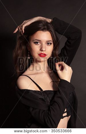 Portrait Of Beautiful Brunette Woman In Black Dress. Fashion Photo.