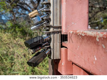 Overkill With Six Different Padlock Locks Securing A Metal Gate From Being Opened