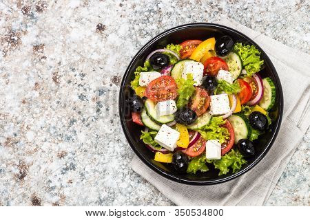 Greek Salad. Vegetable Salad With Tomato, Cucumber, Salad Leaves, Feta Cheese And Olive Oil. Top Vie