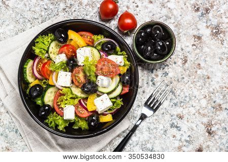 Greek Salad. Vegetable Salad With Tomato, Cucumber, Salad Leaves, Feta Cheese And Olive Oil. Top Vie