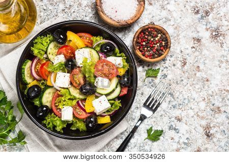 Greek Salad. Vegetable Salad With Tomato, Cucumber, Salad Leaves, Feta Cheese And Olive Oil. Top Vie