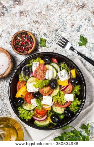 Greek Salad. Vegetable Salad With Tomato, Cucumber, Salad Leaves, Feta Cheese And Olive Oil. Top Vie