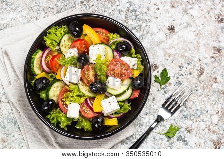 Greek Salad. Vegetable Salad With Tomato, Cucumber, Salad Leaves, Feta Cheese And Olive Oil. Top Vie