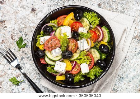 Greek Salad. Vegetable Salad With Tomato, Cucumber, Salad Leaves, Feta Cheese And Olive Oil. Top Vie