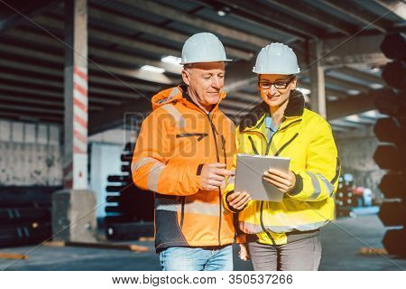 Workers checking inventory of logistics warehouse