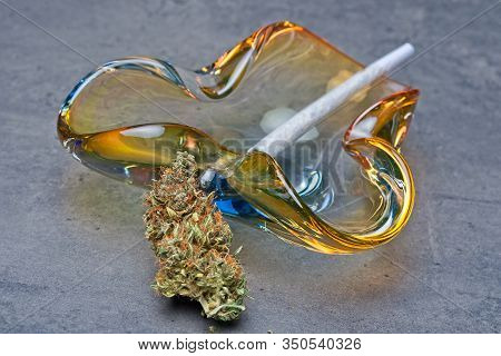 Close Up Of Cannabis - Marijuana Bud And Accessories - Glass Ashtray And Rolled Joint - Splif.