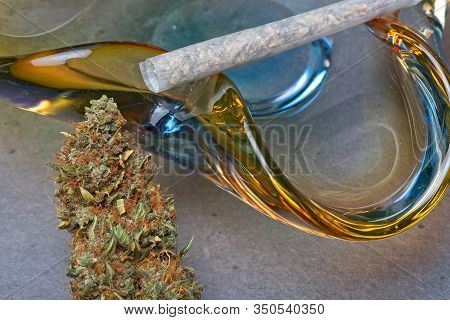 Close Up Of Cannabis - Marijuana Bud And Accessories - Glass Ashtray And Rolled Joint - Splif.