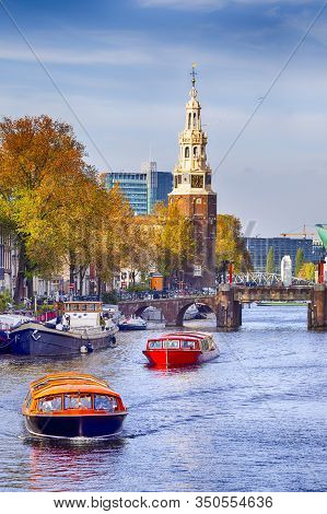 People Traveling. River Boat Cruises In Amsterdam In The Netherlands.vertical Image