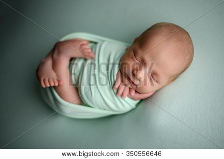 Newborn Baby Boy Sleeping Confort Pose On A Beanbag
