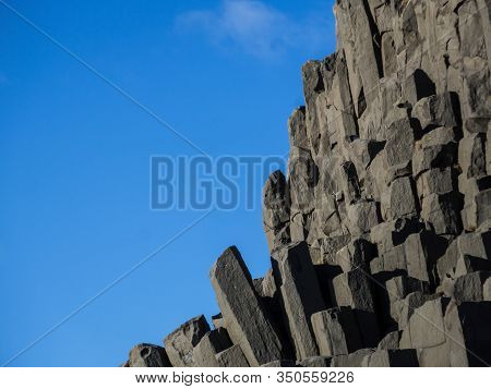 Beautiful Natural Basalt Rock Formation Near Vik, Iceland At Reynisfjara Beach. Column-shaped Black 