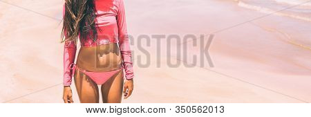 Rashguard solar protection swimwear in pink for women fashion, Bikini woman body lifestyle banner panorama.