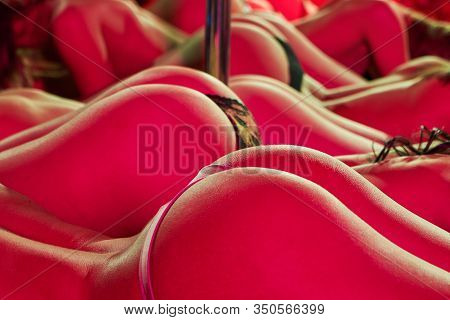 Young Sexy Woman Pole Dancing Striptease With Pylon In Night Club. Beautiful Naked Stripper Girl On 