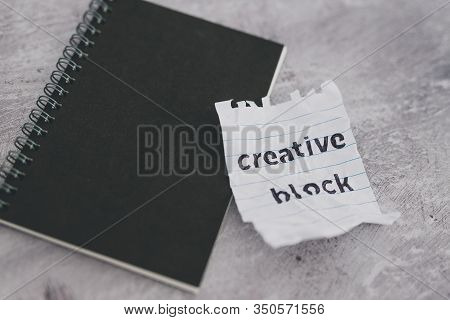 Scrunched Paper With Creative Block Text On Desk With Notepad, Lack Of Inspiration