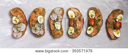 Toasted Rye Bread With Smoked Salmon, Spinach, Radish, And Quial Eggs. Delicious Healthy Snack With 