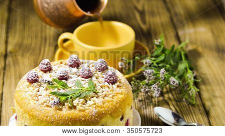 Yellow Cake With Raspberries And Powdered Sugar. Coffee Is Poured Into The Cup. Breakfast.