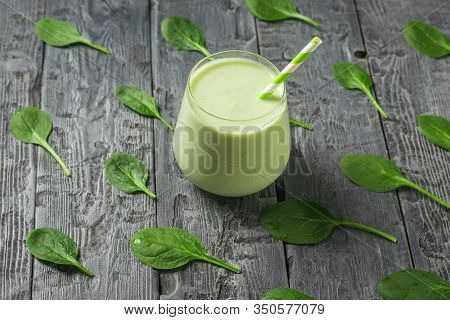 Spinach Leaves On A Wooden Table And A Glass Glass With A Smoothie. Fitness Product. Dietary Sports 