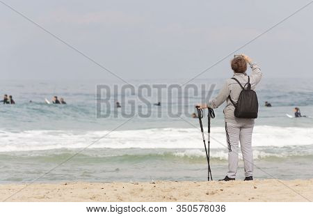 A Tourist Takes A Photo Of The Sea On Her Smartphone