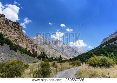 Turkey, Chamard - August 3, 2019: Tourists Walk Along The Road Through The Mountain Landscape In The