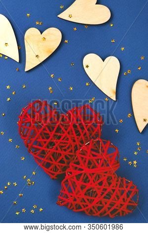 Beautiful Red And Wooden Hearts On The Cornflowerblue Background In The Golden Star Sequins. St Vale