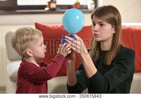 A Boy With A Hearing Aids And Cochlear Implants Playing