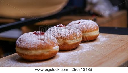 Hanukkah Food Doughnuts With Jelly And Sugar Powder With Bookeh Background. Jewish Holiday Hanukkah