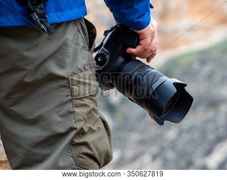 Hand Of A Man In Sport Clothes Holding A Camera In The Rocky Mountain In The Background In Maderuelo