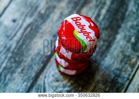 Istanbul, Turkey - February 23, 2018: Mini Babybel Cheese In Red Wax On Wooden Surface.
