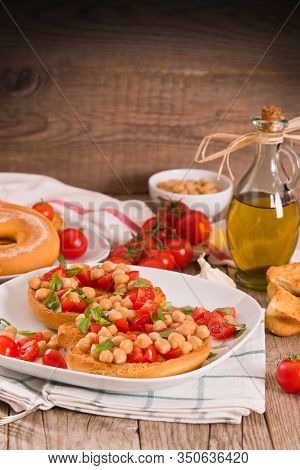 Friselle With Tomatoes And Chickpeas On White Dish.