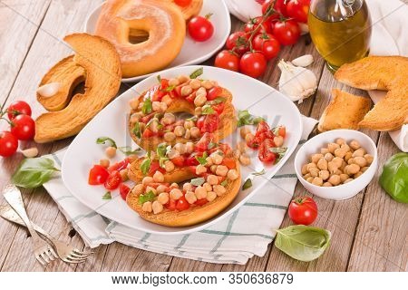 Friselle With Tomatoes And Chickpeas On White Dish.