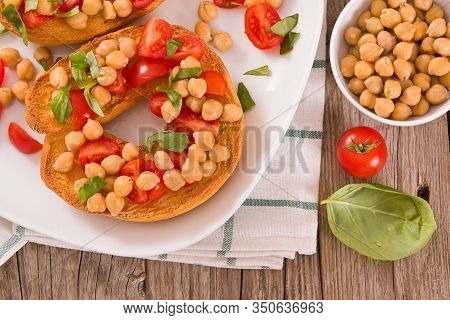 Friselle With Tomatoes And Chickpeas On White Dish.