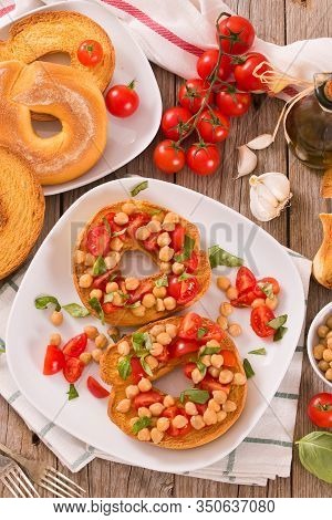 Friselle With Tomatoes And Chickpeas On White Dish.