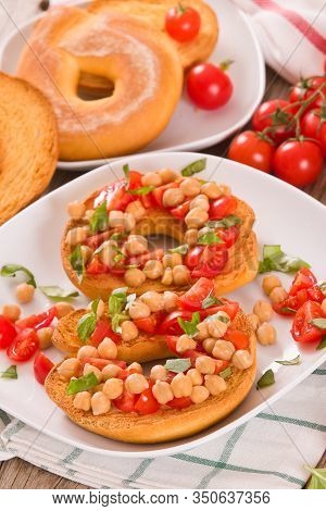 Friselle With Tomatoes And Chickpeas On White Dish.