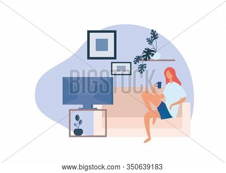 Female Watching Tv At Home. Relaxed Barefoot Woman Drinking Hot Beverage From Mug While Sitting On C