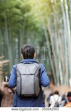 Young Man Traveling At Arashiyama Bamboo Grove, Happy Asian Traveler Looking Sagano Bamboo Forest. L