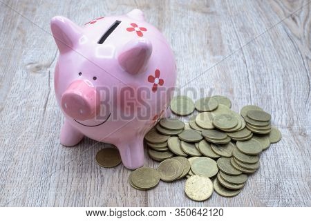 Many Coins On The Table And Pink Piggy Bank, Ideas For Saving Money To Buy A House For The Future, A