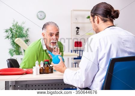 Old man visiting young male doctor gastroenterologist