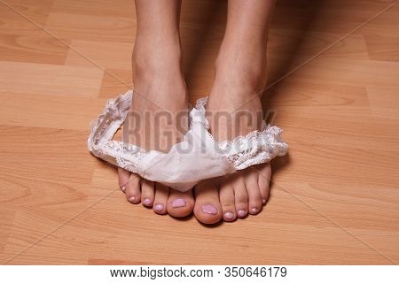 Close-up Feet Of Unrecognizable Young Woman Undressing Dropping White Thong Panties On Bedroom Floor