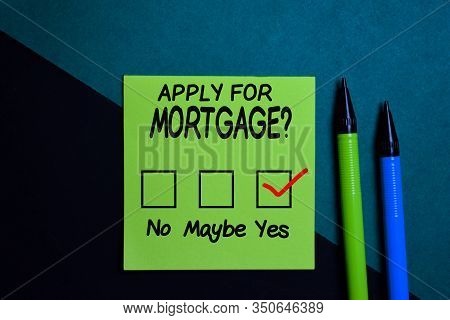 Apply For Mortgage And Chec Kmark Write On A Sticky Note Isolated On Office Desk